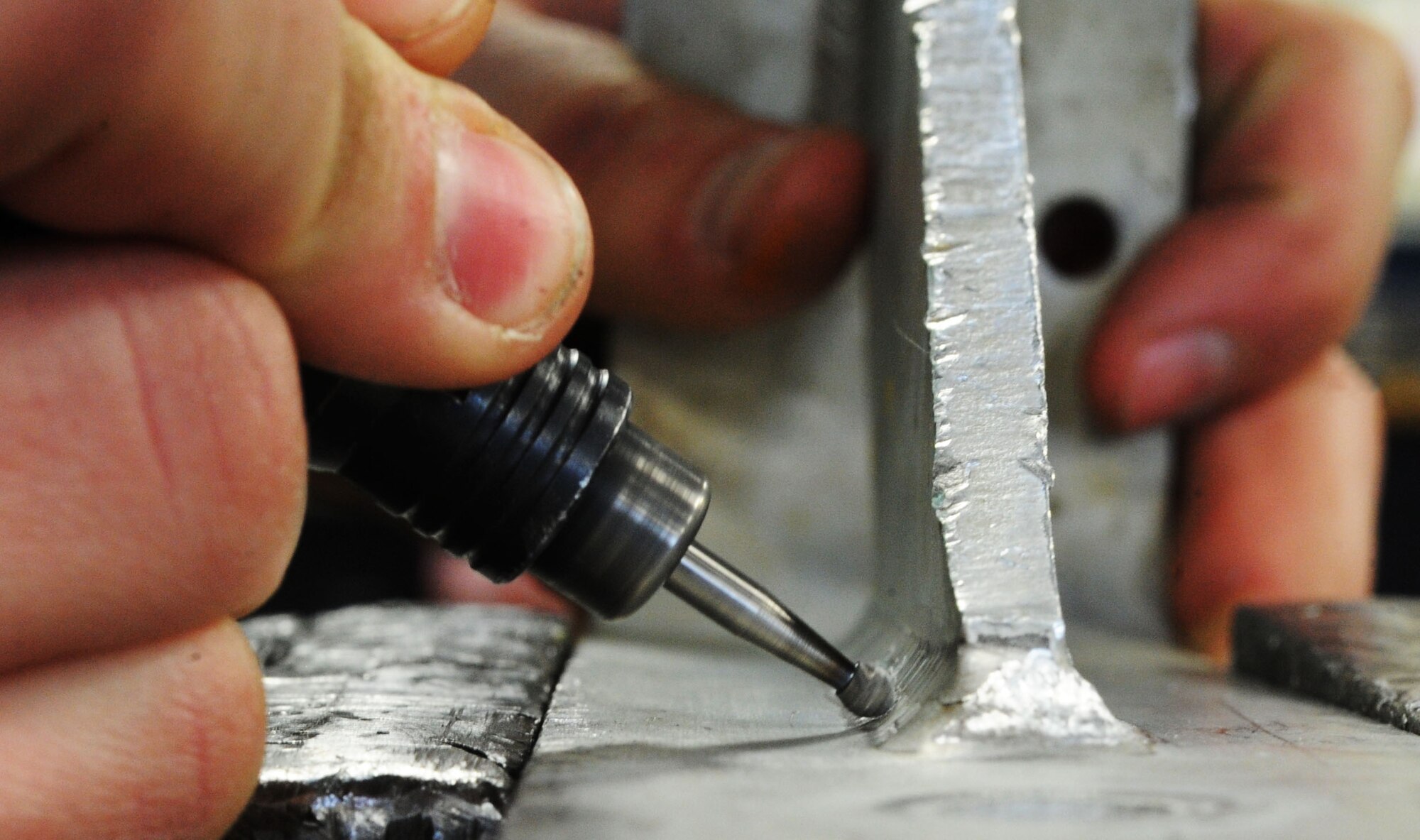 MINOT AIR FORCE BASE, N.D. – Airman 1st Class Allison Corbett, 5th Maintenance Squadron metals technician, prepares a piece of metal for welding here, Jan. 22. When flight line maintainers notice structural discrepancies with an aircraft, metals technicians go to the aircraft and evaluate the problem. (U.S. Air Force photo/Senior Airman Brittany Y. Auld)