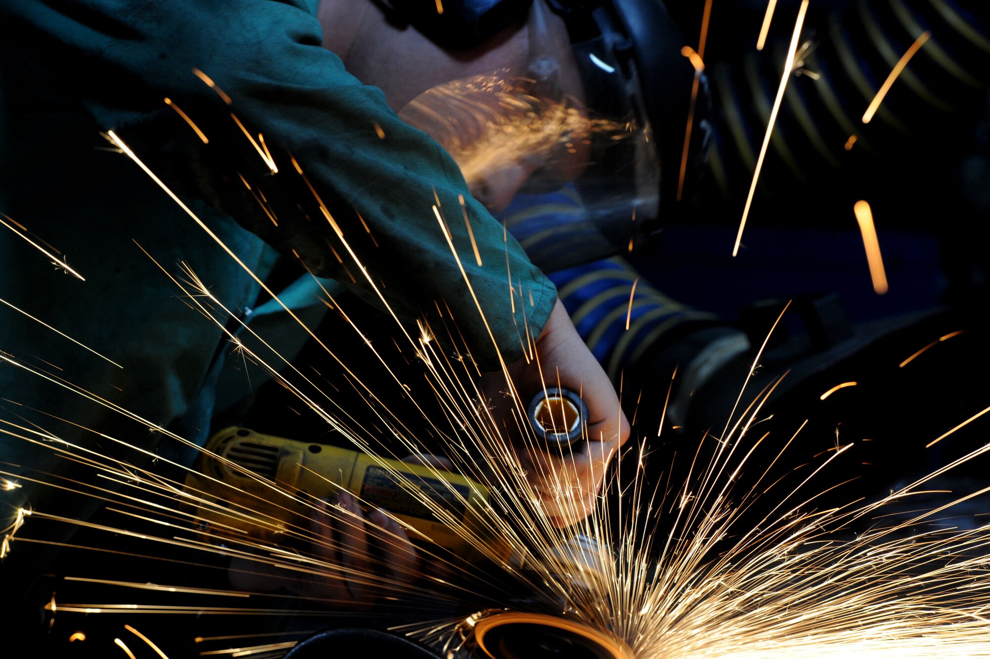 MINOT AIR FORCE BASE, N.D. – Airman 1st Class David Moore, 5th Maintenance Squadron metals technician, welds a piece of damaged equipment here, Jan. 17. The 5th MXS’s  Metals Technology Flight uses a lathe, drill press, torch and imagination to repair, and at times create, parts that are no longer in production. (U.S. Air Force photo/Senior Airman Brittany Y. Auld)