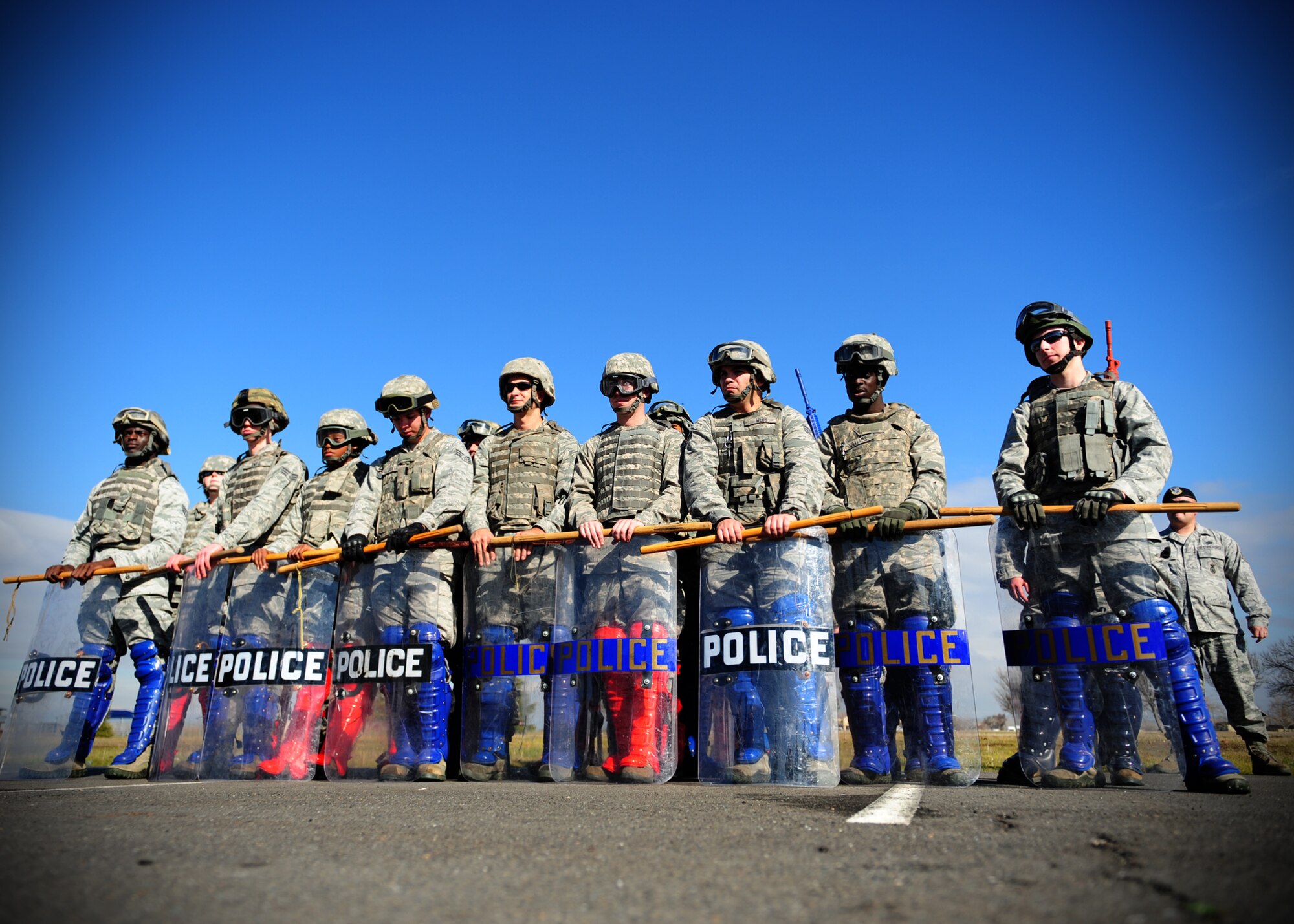 The 9th Security Forces Squadron Bravo Flight stands ready with riot shields and impact weapons during civil disturbance training at Beale Air Force Base, Calif., Jan. 25, 2013. The squadron trains constantly to stay proficient in base defense. (U.S. Air Force photo by Senior Airman Shawn Nickel/Released)