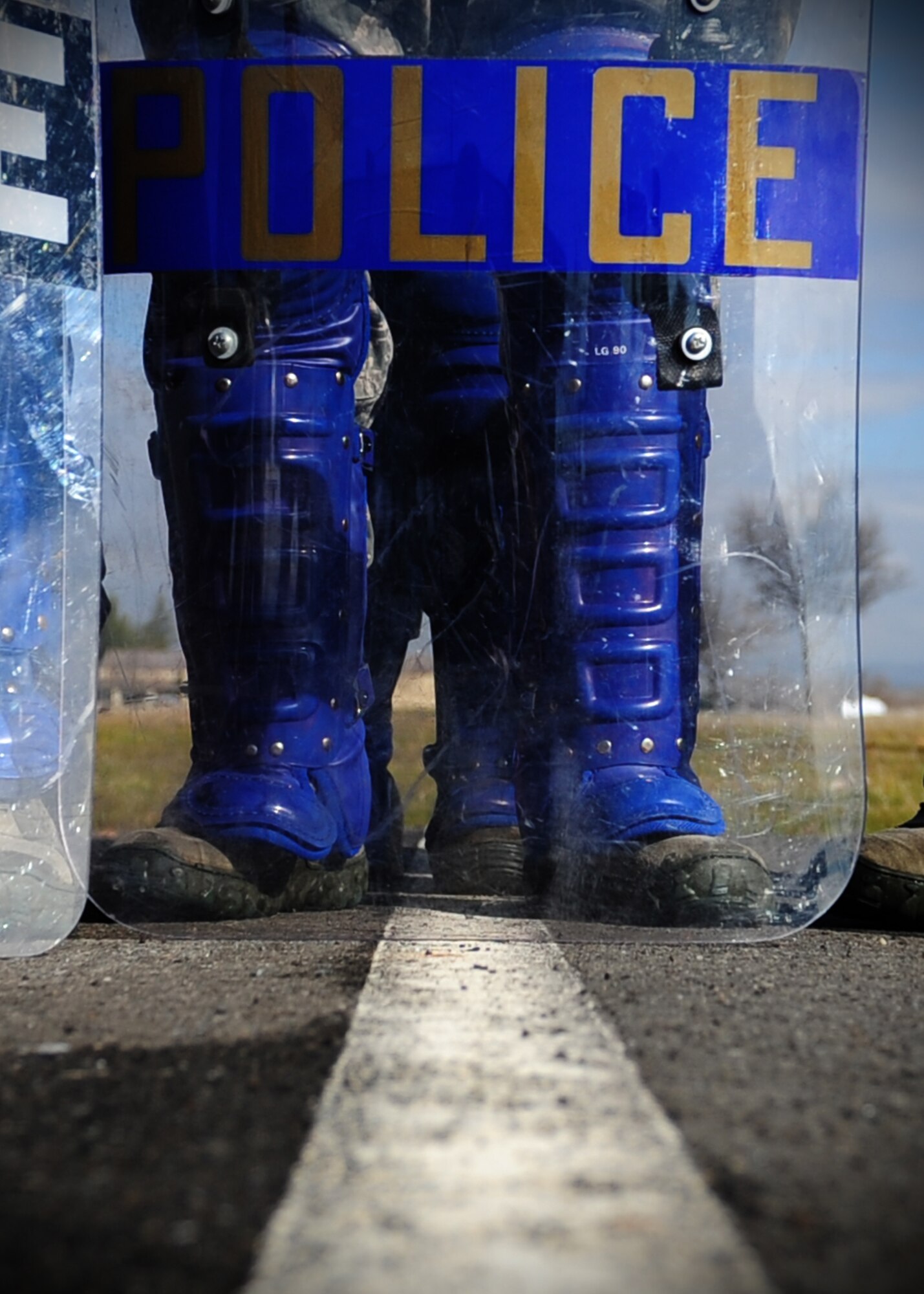 A 9th Security Force Squadron patrolman stands in front of a riot shield in preperation for civil disturbace training at Beale Air Force Base, Calif., Jan. 25, 2013. The squadron trains constantly to stay proficient in base defense. (U.S. Air Force photo by Senior Airman Shawn Nickel/Released)