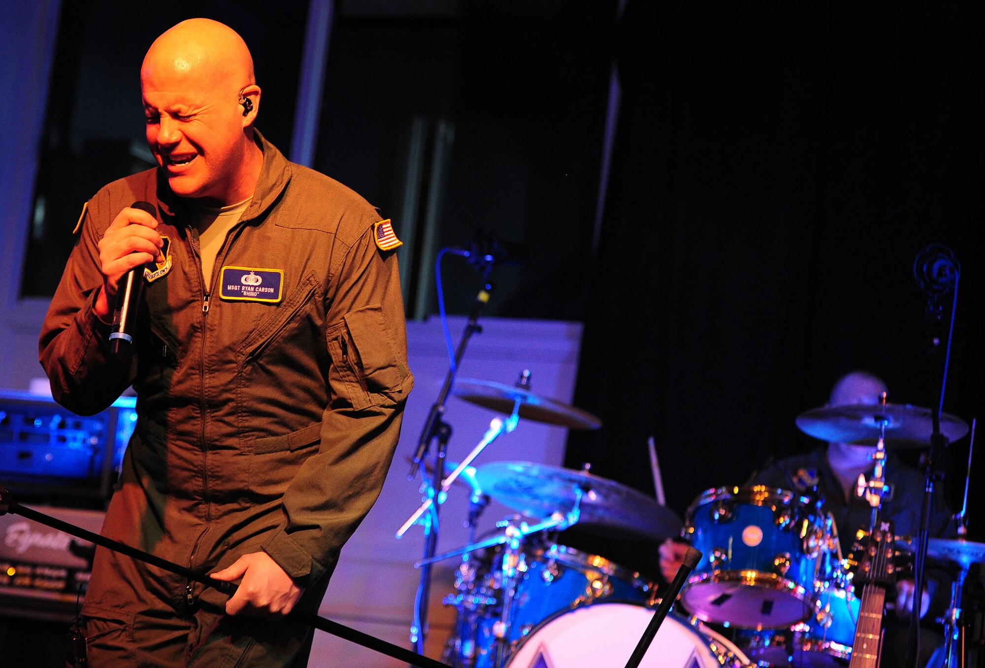 U.S. Air Force Master Sgt. Ryan Carson, Max Impact vocalist, belts out a solo during a show at the Drop Zone at Cannon Air Force Base, N.M., Jan. 26, 2013. Max Impact travels to Air Force bases and deployed locations all over the world, showcasing the Air Force’s excellence through their music. (U.S. Air Force photo/Airman 1st Class Ericka Engblom)