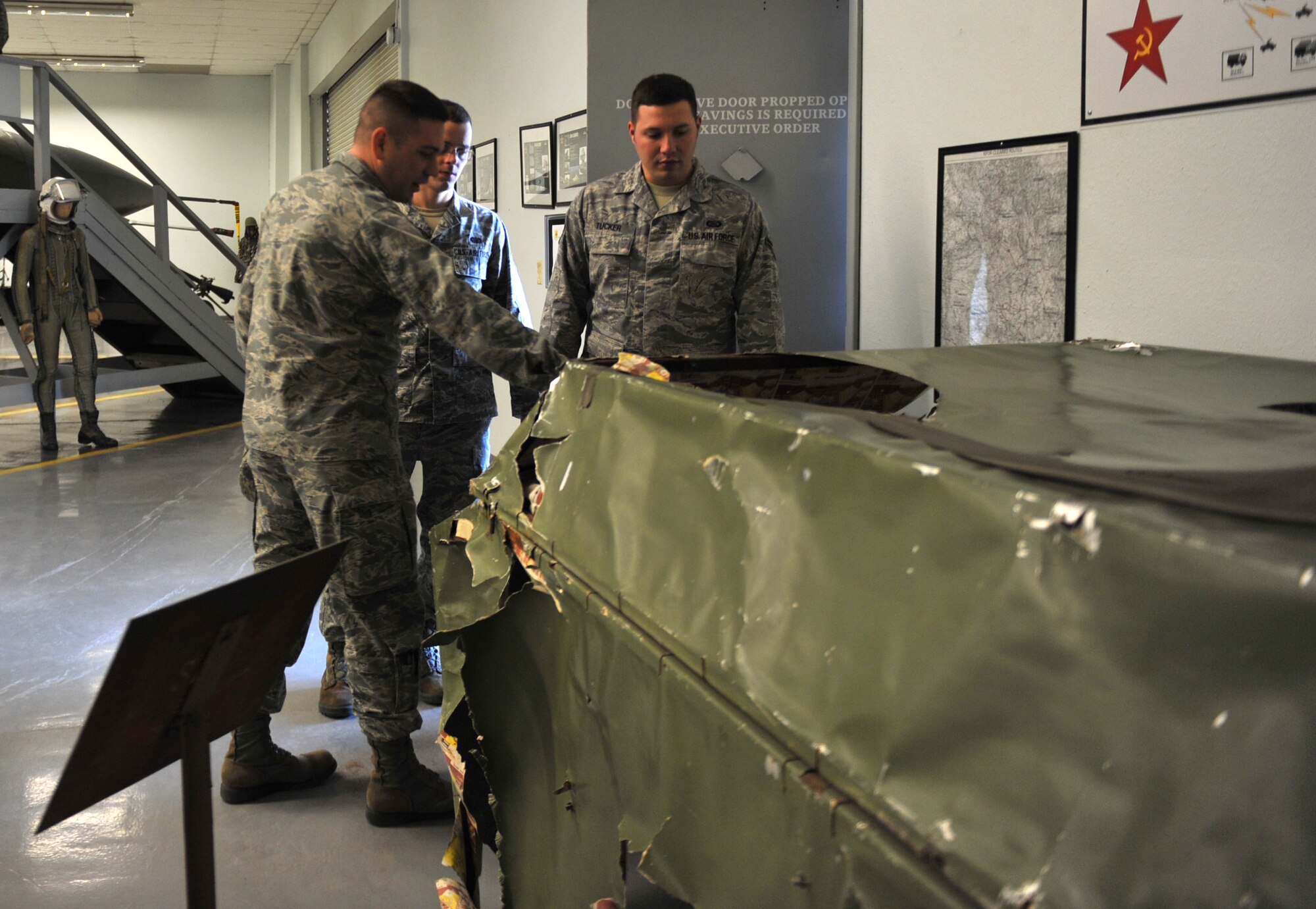 U.S. Air Force Maj. Frank Dillard, 366th Operations Support Squadron senior intelligence officer, shows Airman First Class Joshua Walloga, 366th OSS targeteer, and Senior Airman Anthony Werner, 366th OSS operations intelligence journeyman, a piece of equipment, at Nellis Air Force Base, Nev., Jan. 22, 2013. The airmen were given the chance to see, handle and even sit in the equipment they learned about. (U.S. Air Force photo/Senior Airman Heather Hayward) 
