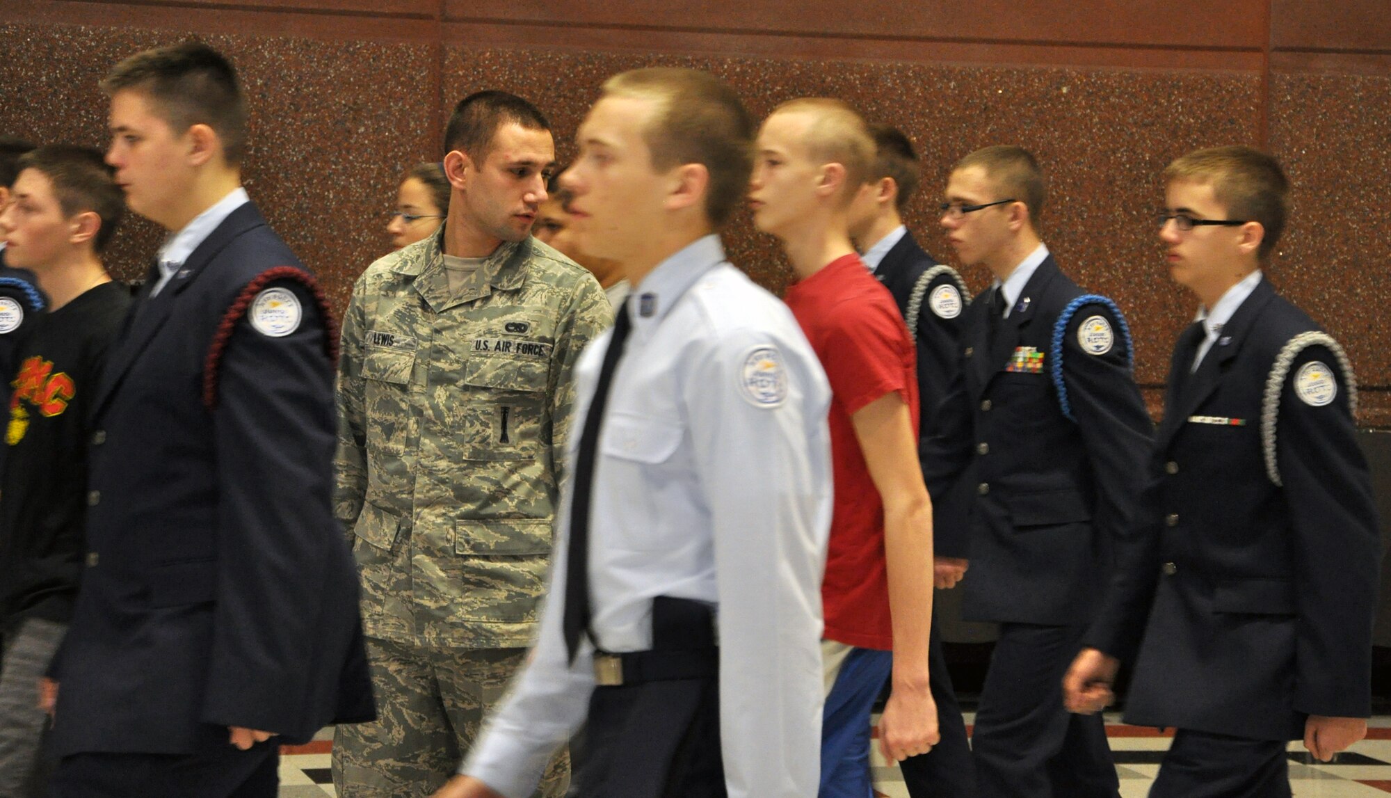 Staff Sgt. Travis Lewis, 509th Bomb Wing Honor Guard assistant noncommisssioned officer in charge, observes members of the Lee's Summit North High School Air Force Junior Reserve Officers' Training Corps march in formation on Jan. 24, 2013. Lewis travels there several times a week to help train the school's AFJROTC program in drill and ceremony. Lewis is a traditional reservist with the 442nd Aircraft Maintenance Squadron, which is part of the 442nd Fighter Wing, an A-10 Thunderbolt II Air Force Reserve unit at Whiteman Air Force Base, Mo. (U.S. Air Force photo by Senior Airman Wesley Wright/released)