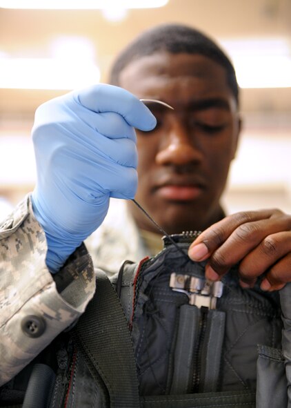 Senior Airman Ernest St. Amand, 2nd Operations Support Squadron Aircrew Flight Equipment parachute shop, threads part of a back automatic parachute, BA-18, on Barksdale Air Force Base, La., Jan. 25. The BA-18 is worn by aircrew members during flight and deploys in the event of an egress. (U.S. Air Force photo/Airman 1st Class Benjamin Gonsier)