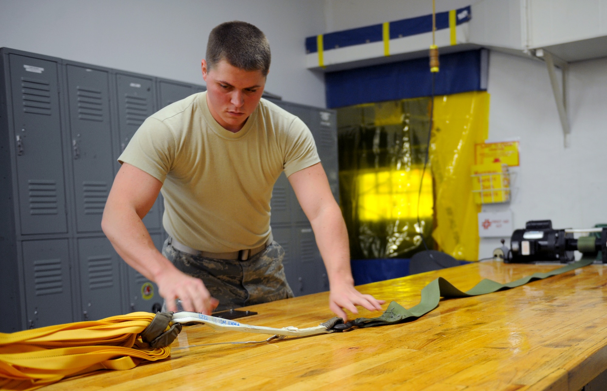 Airman 1st Class Tyler Shepherd, 2nd Operations Support Squadron Aircrew Flight Equipment parachute shop, connects a drag chute to a table for inspection on Barksdale Air Force Base, La., Jan. 25. The AFE parachute shop is in charge of packing, inspecting, and supplying B-52H Stratofortress aircrew with their parachutes. (U.S. Air Force photo/Airman 1st Class Benjamin Gonsier)