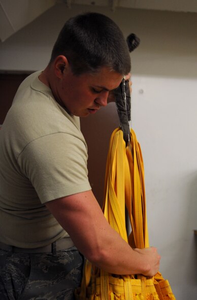 Airman 1st Class Tyler Shepherd, 2nd Operations Support Squadron Aircrew Flight Equipment parachute shop, inspects a drag chute for holes and tears on Barksdale Air Force Base, La., Jan. 25. The AFE parachute shop is in charge of packing, inspecting, and supplying B-52H Stratofortress aircrew with their parachutes. The drag chute is 185 pounds and is used to slow down an aircraft after landing. (U.S. Air Force photo/Airman 1st Class Benjamin Gonsier)