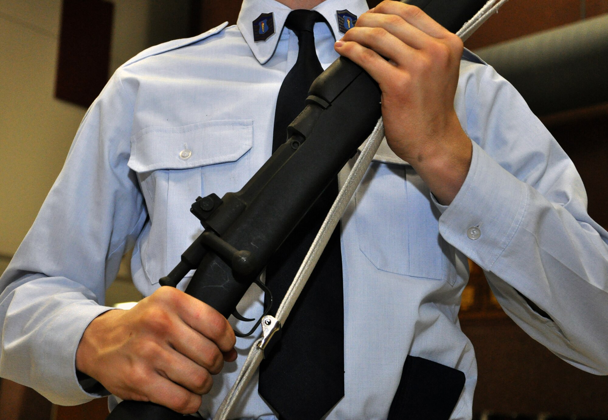 A student at Lee's Summit North High School stands at attention with a training rifle on Jan. 24, 2013. Staff Sgt. Travis Lewis, 509th Bomb Wing Honor Guard assistant noncommisssioned officer in charge, travels there several times a week to help train the school's Air Force Junior Reserve Officers' Training Corps in drill and ceremony. Lewis is a traditional reservist with the 442nd Aircraft Maintenance Squadron, which is part of the 442nd Fighter Wing, an A-10 Thunderbolt II Air Force Reserve unit at Whiteman Air Force Base, Mo. (U.S. Air Force photo by Senior Airman Wesley Wright/released) 