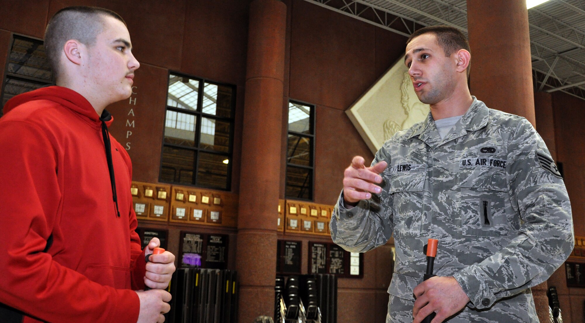 Staff Sgt. Travis Lewis, 509th Bomb Wing Honor Guard assistant noncommisssioned officer in charge, helps a Lees Summit North High School student with a drill and ceremony question on Jan. 24, 2013.  Lewis travels there several times a week to help train the school's Air Force Junior Reserve Officers' Training Corps in drill and ceremony. Lewis is a traditional reservist with the 442nd Aircraft Maintenance Squadron, which is part of the 442nd Fighter Wing, an A-10 Thunderbolt II Air Force Reserve unit at Whiteman Air Force Base, Mo. (U.S. Air Force photo by Senior Airman Wesley Wright/released) 