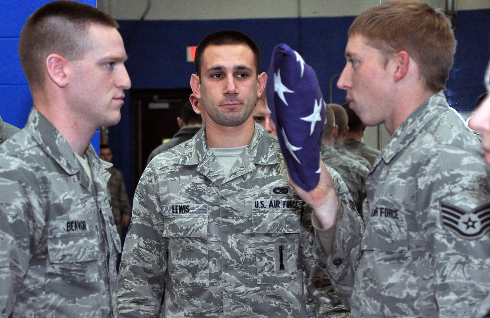 Staff Sgt. Travis Lewis, 509th Bomb Wing Honor Guard, observes as Senior Airman Nathan Beavor and Staff Sgt. Andrew Richardson, both of the base honor guard, perform a flag folding ceremony on Jan. 24, 2013.  Lewis also travels to Lee's Summit North High School several times a week to help train the school's Air Force Junior Reserve Officers' Training Corps in drill and ceremony. Lewis is a traditional reservist with the 442nd Aircraft Maintenance Squadron, which is part of the 442nd Fighter Wing, an A-10 Thunderbolt II Air Force Reserve unit at Whiteman Air Force Base, Mo. (U.S. Air Force photo by Senior Airman Wesley Wright/released)