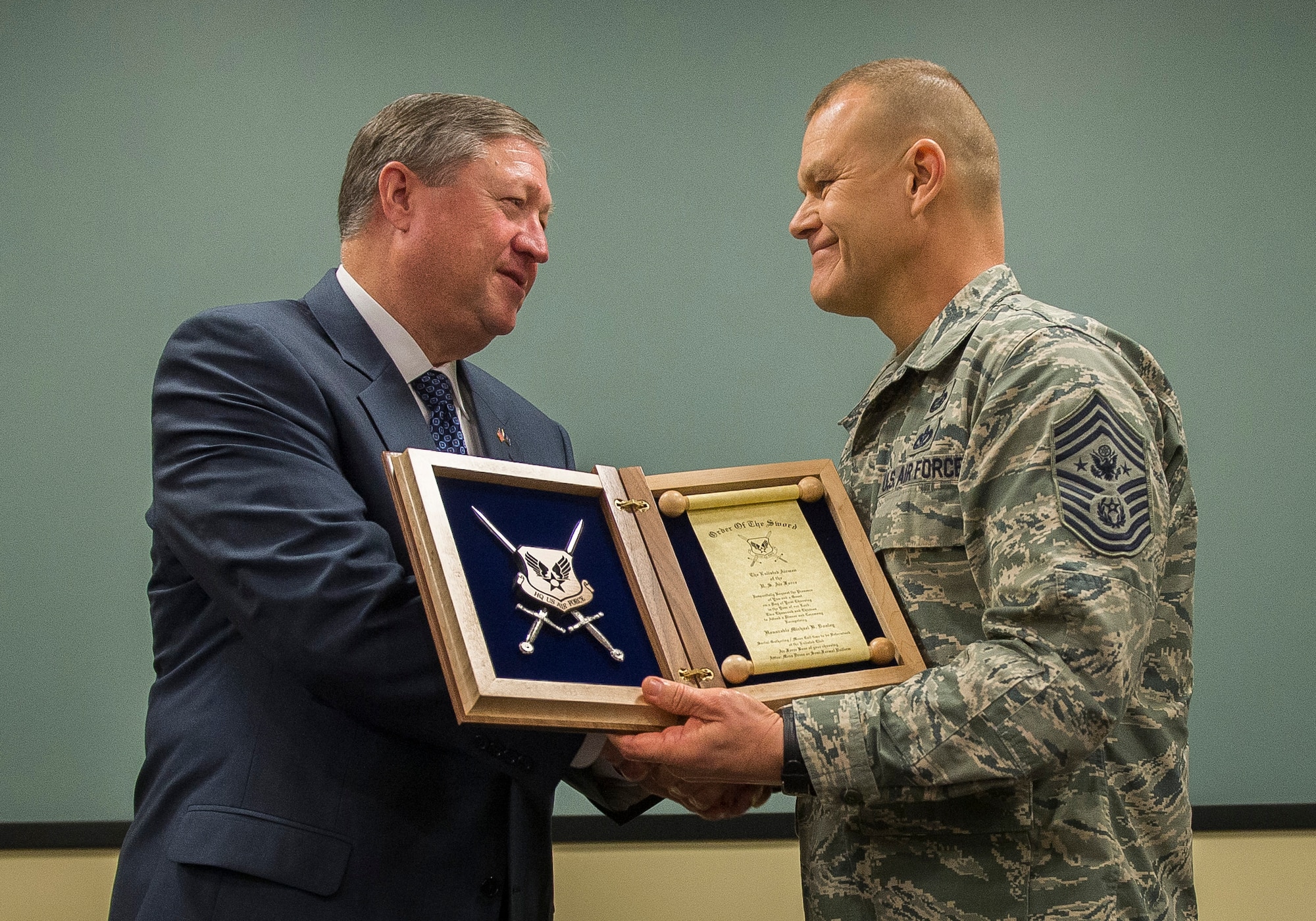 Secretary of the Air Force Michael Donley accepted the Air Force Order of the Sword nomination from Chief Master Sgt. of the Air Force James Roy at a meeting with former chief master sergeants of the Air Force and current combatant-level and major command-level command chief master sergeants at Joint Base Andrews, Md., Jan. 23, 2013. The Order of the Sword has been given to 246 people. Donley is the third secretary of the Air Force to be inducted into the order. He follows the Honorable F. Whitten Peters, inducted in 2000, and the Honorable James A. Roche, inducted in 2003. (U.S. Air Force photo/Jim Varhegyi)