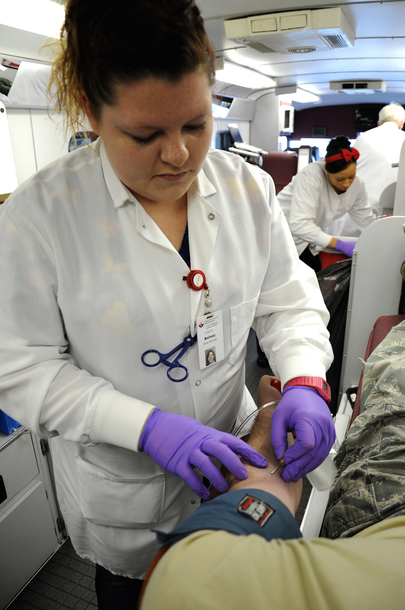 Kelsey Mathison draws a unit of blood using the Haemonetics machines which allows the donor to give a double unit of red blood cells.  The Inland Northwest Blood Center parked the parking lot of the Exchange, Fairchild Air Force Base, Wash., Jan. 25, 2013. The advantage of donating a double unit of red blood cells is that it lessens any reactions with the donor and the recipient. (US Air Force Photo by Senior Airman Jordan Pollock)     