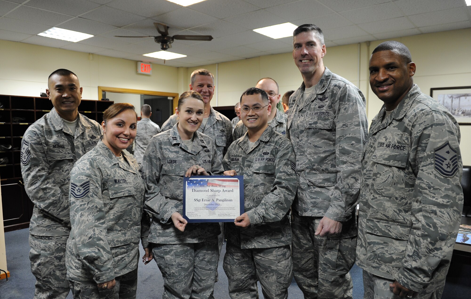 Staff Sgt. Ernie Pangilinan, 39th Air Base Wing knowledge operator, receives the Diamond Sharp award from the Incirlik First Sergeants group Jan. 24, 2013, at Incirlik Air Base, Turkey. Pangilinan earned the monthly award by distinguishing himself through outstanding professionalism, performance and display of the Air Force core values. (U.S. Air Force photo by Staff Sgt. Marissa Tucker/Released)

