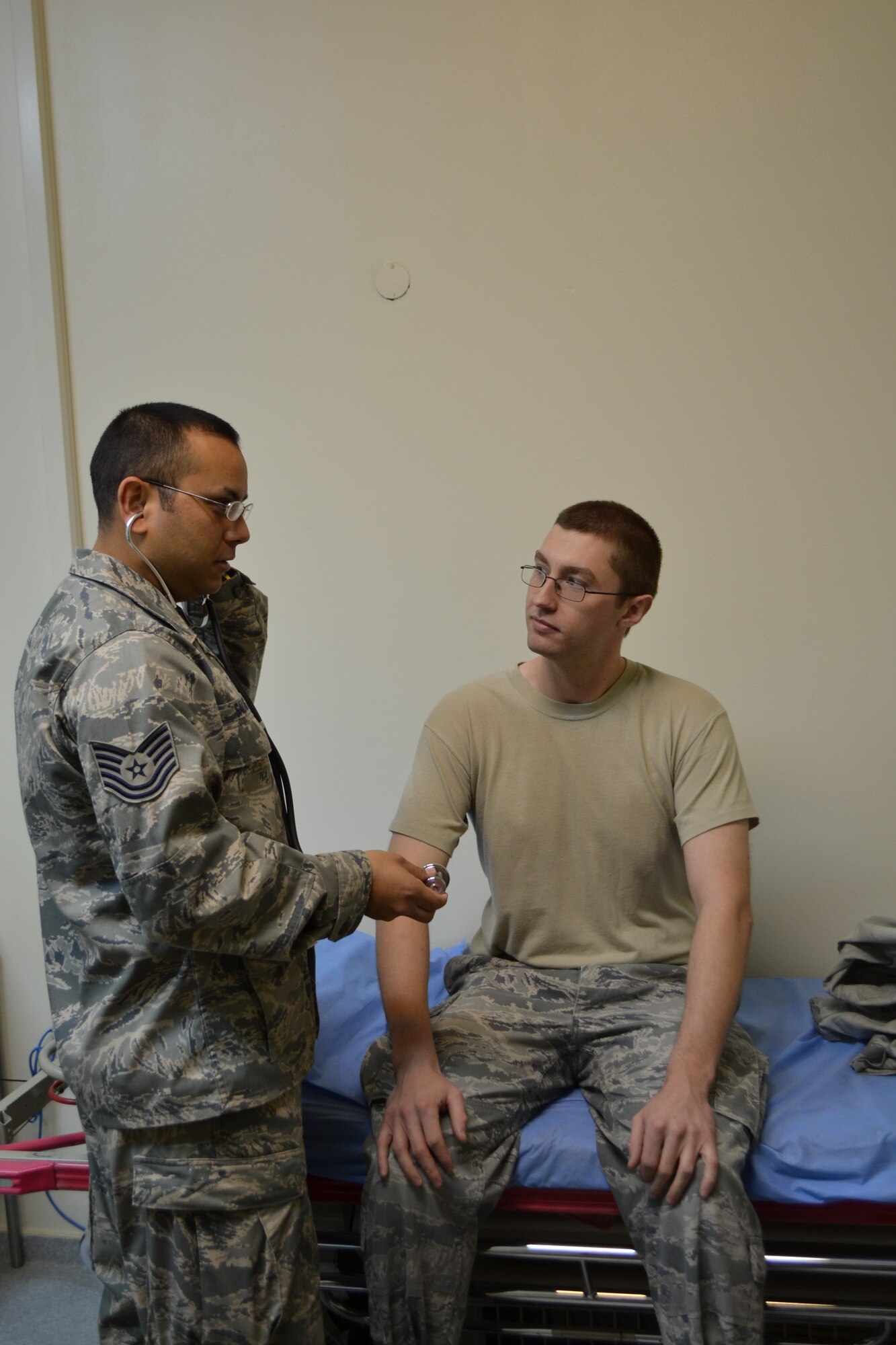 SOUTHWEST ASIA - Tech. Sgt. Oscar Salas checks the vital signs of Senior Airman Nicholas Olson. Both are assigned to the 64th Expeditionary Support Squadron. (U.S. Air Force photo/Staff Sgt. Cynthia Brockes)