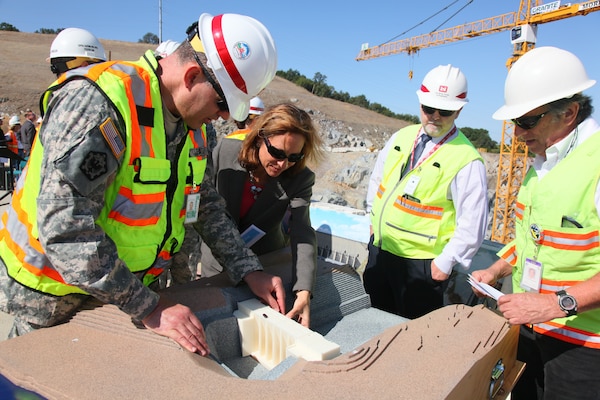 Sacramento District commander Col. Bill Leady shows off a 1/240-scale model of the Folsom Dam auxiliary spillway in Folsom, Calif., during a site visit in May 2012. The Corps uses models created with a 3-D printer to help show team members, community leaders and the public how projects will look and operate.