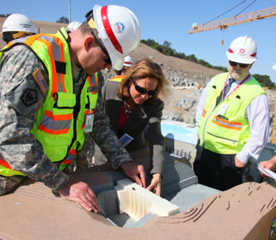 Sacramento District commander Col. Bill Leady shows off a 1/240-scale model of the Folsom Dam auxiliary spillway in Folsom, Calif., during a site visit in May 2012. The Corps uses models created with a 3-D printer to help show team members, community leaders and the public how projects will look and operate. 