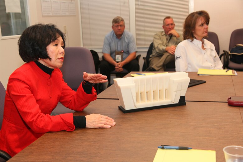 U.S. Rep. Doris Matsui discusses the construction of the “second dam” being installed at Folsom Dam with project staff in Folsom, Calif., in February 2011. The Corps uses a 1/240-scale model of the dam created with a 3-D printer to help explain how the project will work. 