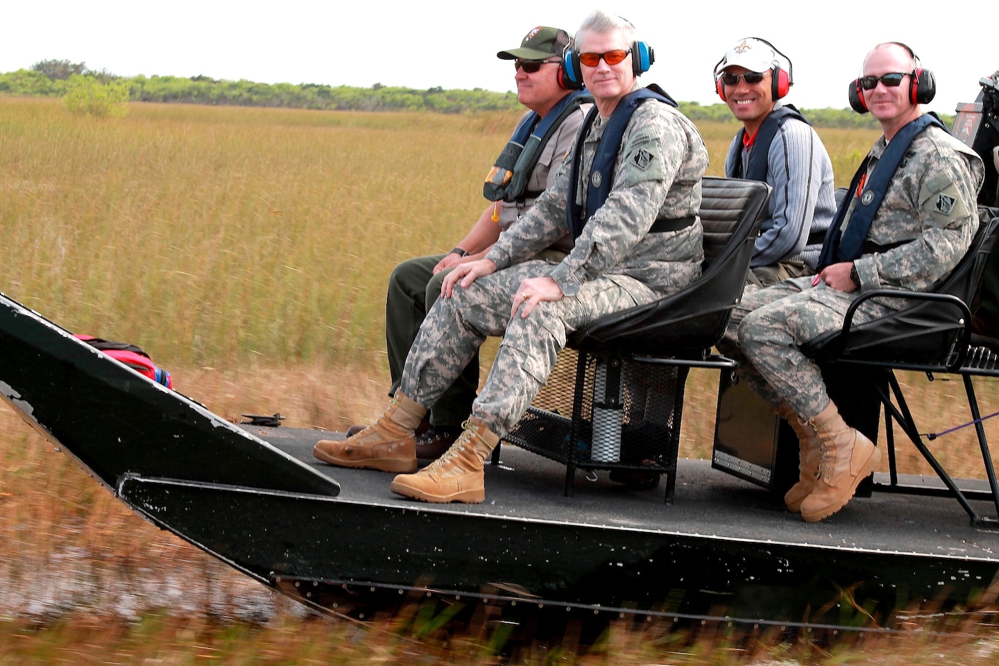 After visiting the Tamiami Trail bridge site, Maj. Gen. Michael J. Walsh, Deputy Commanding General for Civil and Emergency Operations for the U.S. Army Corps of Engineers, took an airboat ride through the Everglades alongside Dan Kimball  (left), superintendant of Everglades National Park, Col. Alan Dodd, Jacksonville District commander (right), and Howie Gonzales, chief of the Jacksonville District's Ecosystem Branch Jan. 23, 2013.             