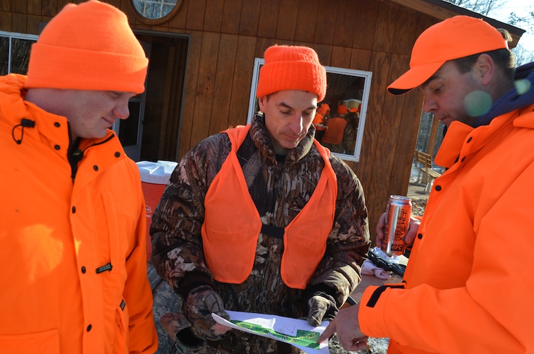Derrick Ostlie, left; Col. Michael Price, St. Paul District commander, and Matt Lehto review a map prior to a wounded warrior hunt at Eau Galle Recreation Area, near Spring Valley, Wis., Dec. 8. Both Ostlie and Lehto are members of the Wounded Warrior Project.