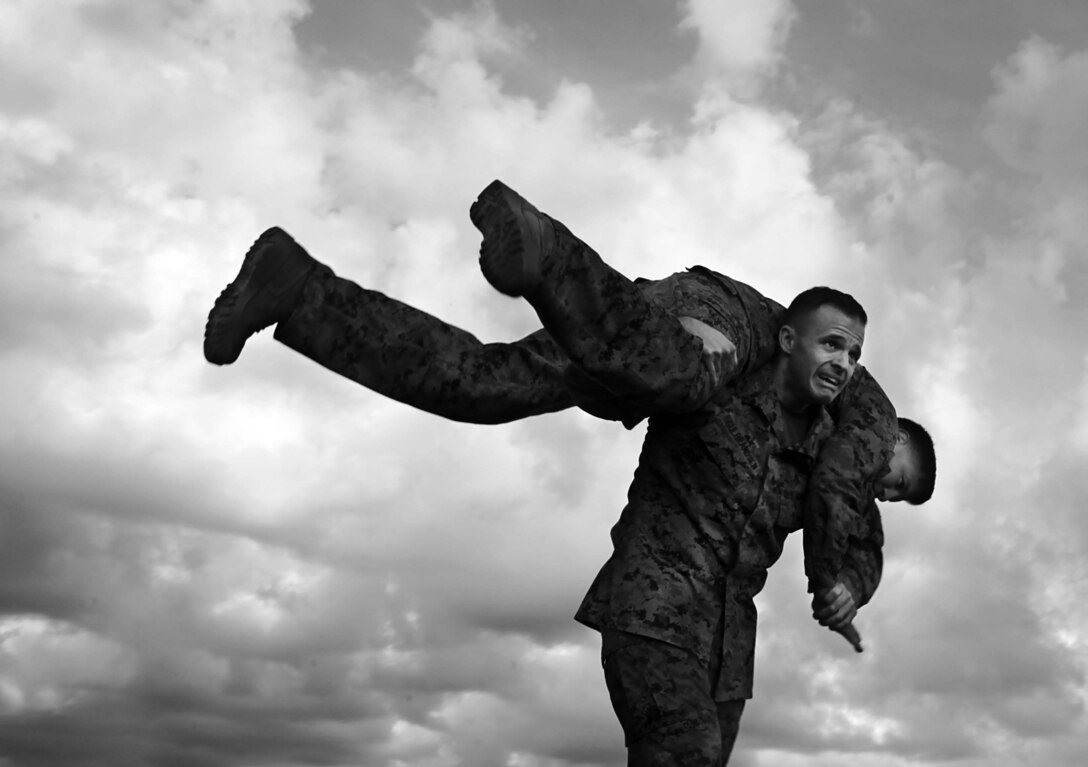 Lt. Col. Paul Gulbrandsen lifts Capt. Jose Mireles during the buddy carry portion of the Marine Corps Combat Fitness Test aboard Marine Corps Base Camp Lejeune Dec. 20. (Photo by Sgt. Bobby J. Yarbrough)