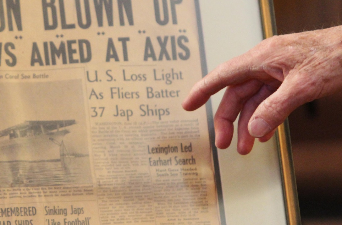 Robert D. Gale, a retired lieutenant commander with the Navy and a Los Angeles native, points to a photo during a Warriors of the Faith event at the Marine Corps Air Station Miramar Chapel aboard MCAS Miramar, Calif., Jan. 23. Gale pointed out that the newspaper had the wrong photo and the ship shown was not the USS Lexington. 