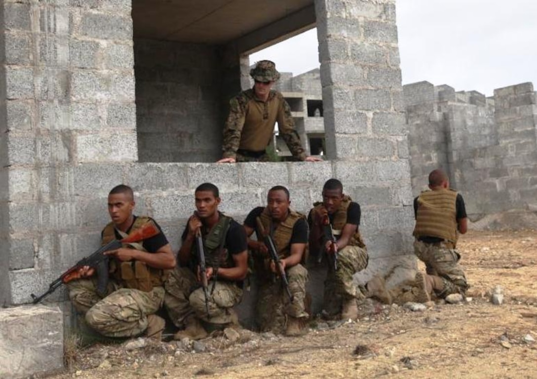 U.S. Marine Staff Sgt. Robert Plemmons, Special Purpose Marine Air-Ground Task Force 13.1, Marine Forces Africa chief close-quarter battle instructor, teaches team stacking drills to members of the Seychelles People's Defense Force Tazar Special Forces Unit Dec. 3-7, 2012, at Sans Souci, Seychelles. The Marines and SPDF Tazar Special Forces partnered to enhance the SPDF's capabilities in conducting counter-piracy operations. The engagement also helped build and sustain the relationship between U.S. and Seychelles military forces.