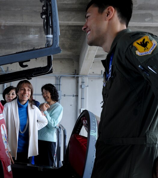 U.S. Air Force 1st Lt. Aaron Eshkenazi, 44th Fighter Squadron pilot, speaks with Andrea Weathers, Okinawa International Women's Club member, during a base tour on Kadena Air Base, Japan, Jan. 28, 2013. More than 30 club members came to Kadena to gain insight and a better understanding of the 18th Wing's mission. (U.S. Air Force photo/Airman 1st Class Justin Veazie)