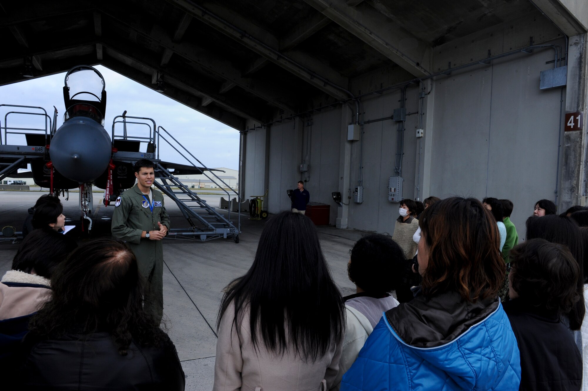 U.S. Air Force 1st Lt. Aaron Eshkenazi, 44th Fighter Squadron pilot, briefs the Okinawa International Women's Club on basic facts about the F-15 Eagle during a base tour on Kadena Air Base, Japan, Jan. 28, 2013. The OIWC is an organization made up of various women from different parts of the world who come together to promote friendship and cultural exchange. (U.S. Air Force photo/Airman 1st Class Justin Veazie)