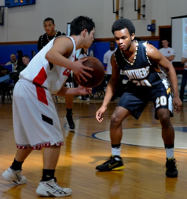 Andre Chilton, son of Tech. Sgt. Andre Chilton, Kadena's base basketball team coach, plays defense on an opposing team's point guard during the Okinawan-American Friendship Tournament at the Risner Fitness Center on Kadena Air Base, Japan, Jan. 26, 2013. The tournament was for American and Japanese players to come together in fellowship and speak the national language of basketball. It was sponsored by the U.S. Consulate and Department of Defense Education Activity Okinawa District schools. (U.S. Air Force photo/Airman 1st Class Justin Veazie)