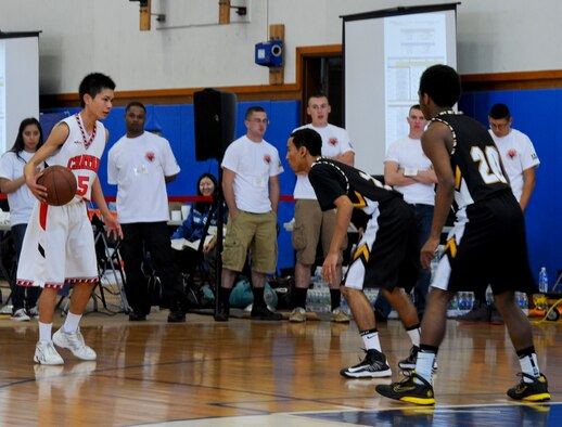 A Chatan High School basketball player tries to take on two Kadena High School varsity basketball players during the Okinawan-American Friendship Tournament at the Risner Fitness Center on Kadena Air Base, Japan, Jan. 26, 2013. The tournament was a way to show how the two different cultures play the sport and interact with each other. (U.S. Air Force photo/Airman 1st Class Justin Veazie)