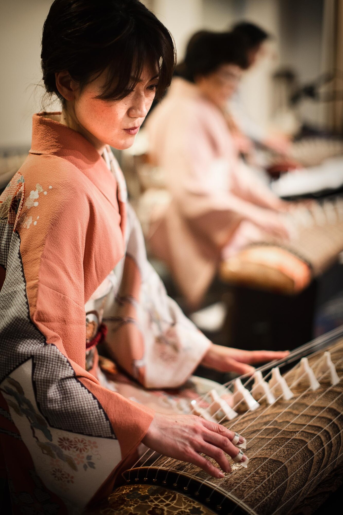 A member of the Japanese koto music group, Kin-yu-kai, performs during a New Year's event hosted at Yokota Air Base, Japan, Jan. 26, 2013. The koto players accompanied Band of the Pacific-Asia jazz ensemble Pacific Showcase for a bilateral performance of "Sakura." (U.S. Air Force photo by Staff Sgt. Josh Voyles)