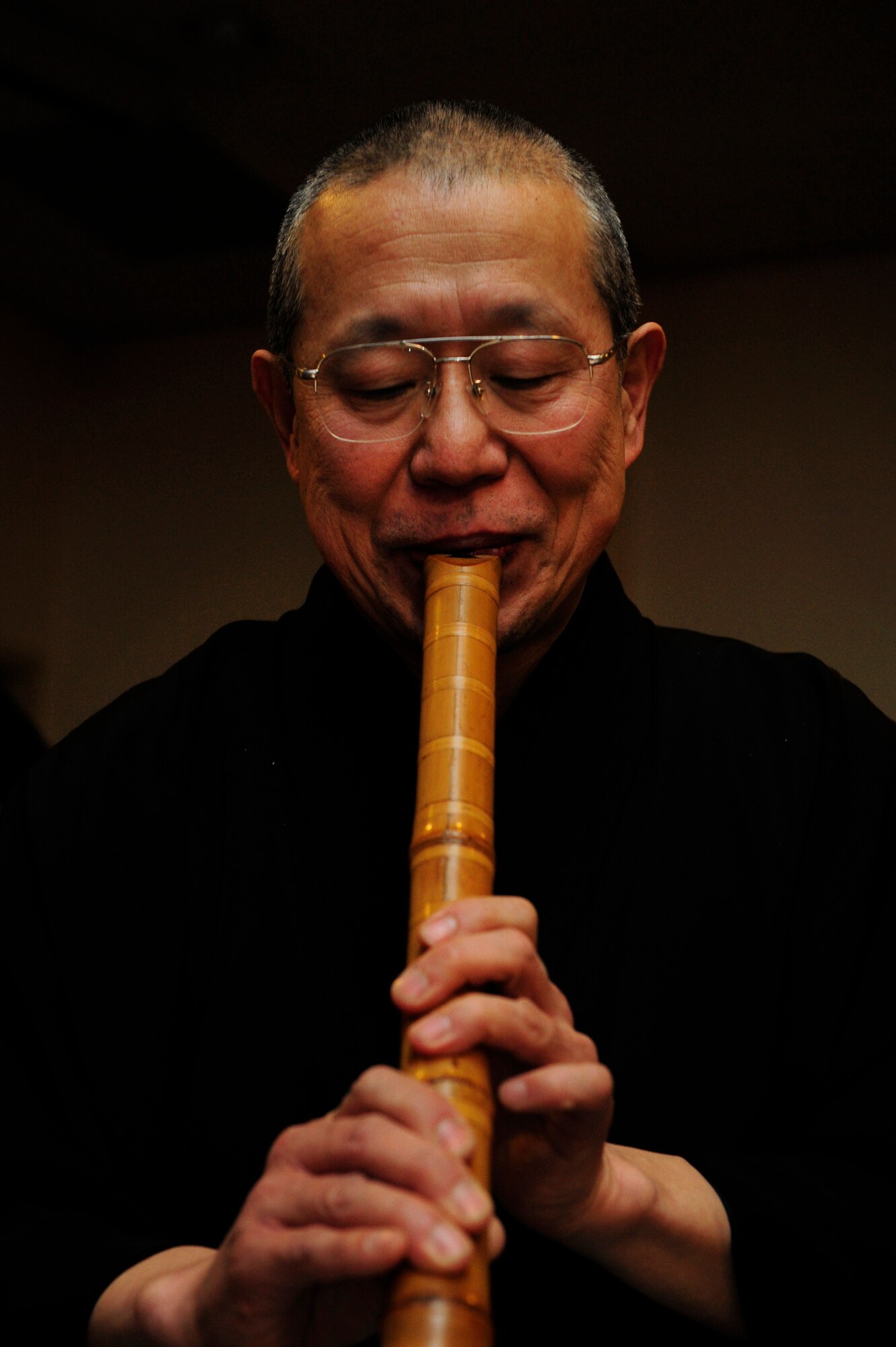 A member of the Japanese koto music group, Kin-yu-kai, performs during a New Year's celebration hosted at Yokota Air Base, Japan, Jan. 26, 2013. During the event, koto players accompanied Band of the Pacifi-Asia jazz ensemble Pacific Showcase for a bilateral performance of "Sakura." (U.S. Air Force photo by 2nd Lt. Jake Bailey)