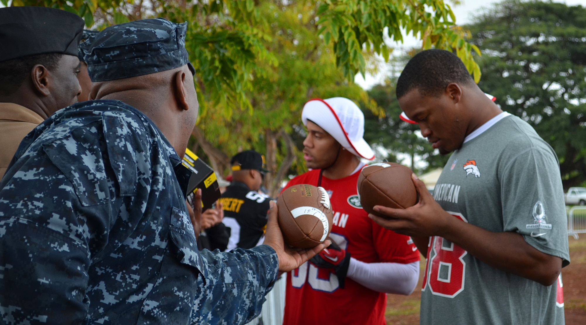 National Football League Pro Bowl players Laron Landry of the New York Jets and Denarius Thomas of the Denver Broncos sign autographs for Joint Base Pearl Harbor-Hickam service members during the 2013 Pro Bowl practice at Earhart Field, JBPHH, Hawaii, Jan. 24, 2013.  (U.S. Air Force photo/Tech. Sgt. Jerome S. Tayborn)