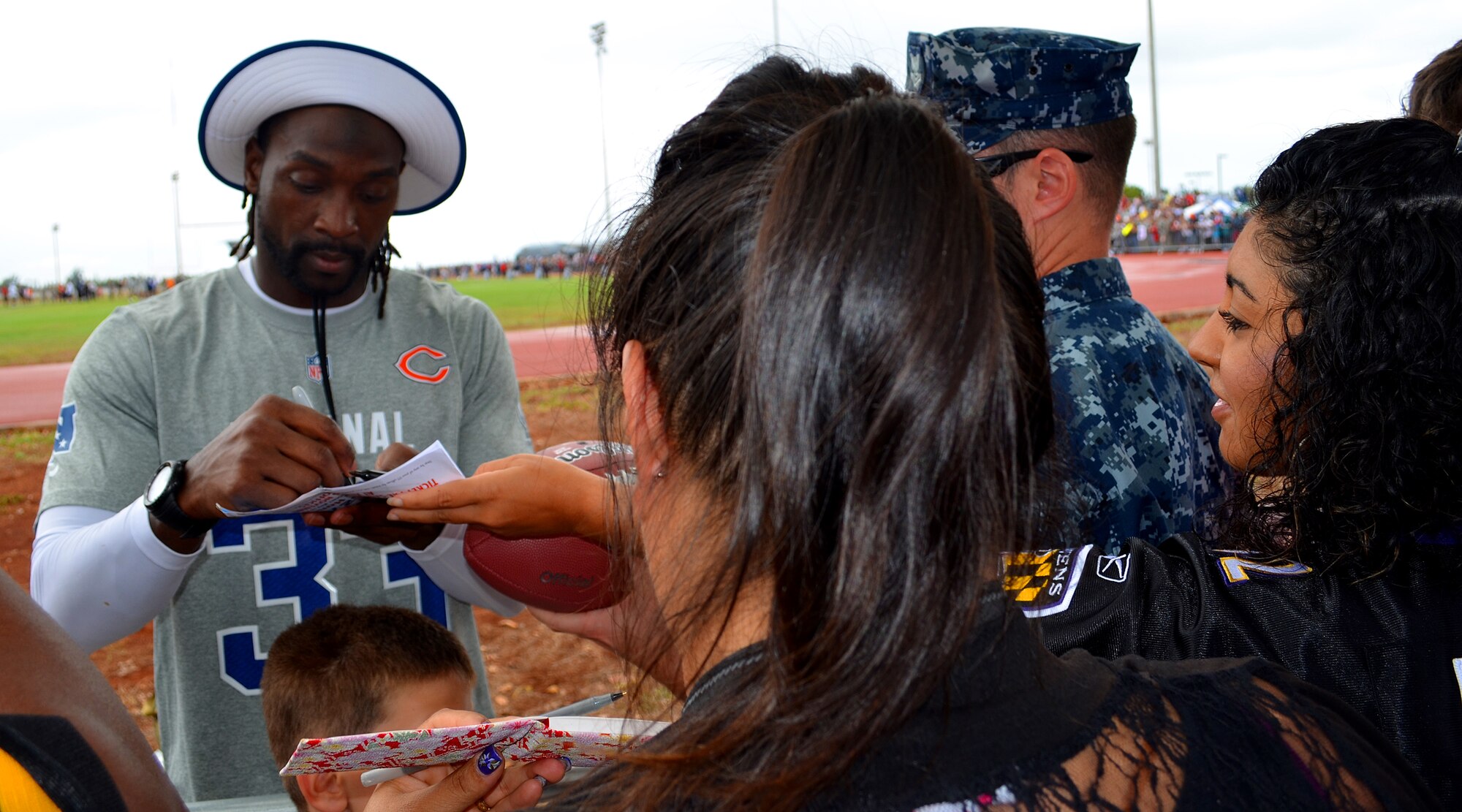 National Football Conference Pro Bowl player Charles Tillman of the Chicago Bears signs autographs for Joint Base Pearl Harbor-Hickam service members and their families’ during the 2013 Pro Bowl practice at the Earhart Field, JBPHH, Hawaii, Jan. 24, 2013.  (U.S. Air Force photo/Tech. Sgt. Jerome S. Tayborn)
