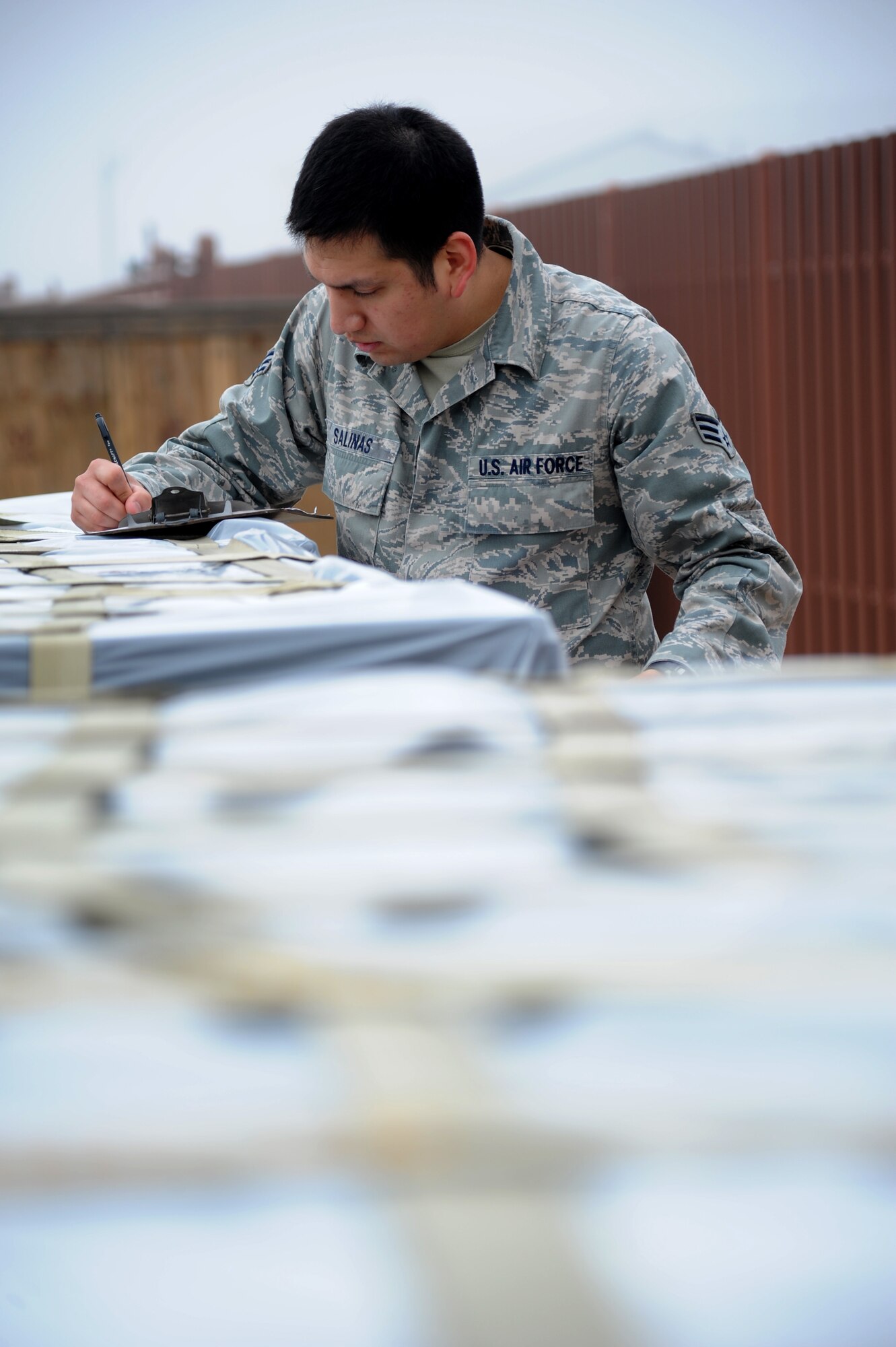 Augmentee Senior Airman Oracio Salinas, 85th Engineering Installation Squadron, checks incoming cargo during a humanitarian deployment exercise Jan. 29, 2013, at the Taylor Logistics Center, Keesler Air Force Base, Miss.  The exercise scenario consists of an earthquake in Arkansas with a warning order for a deployment to Little Rock, Ark.  (U.S. Air Force photo by Kemberly Groue)