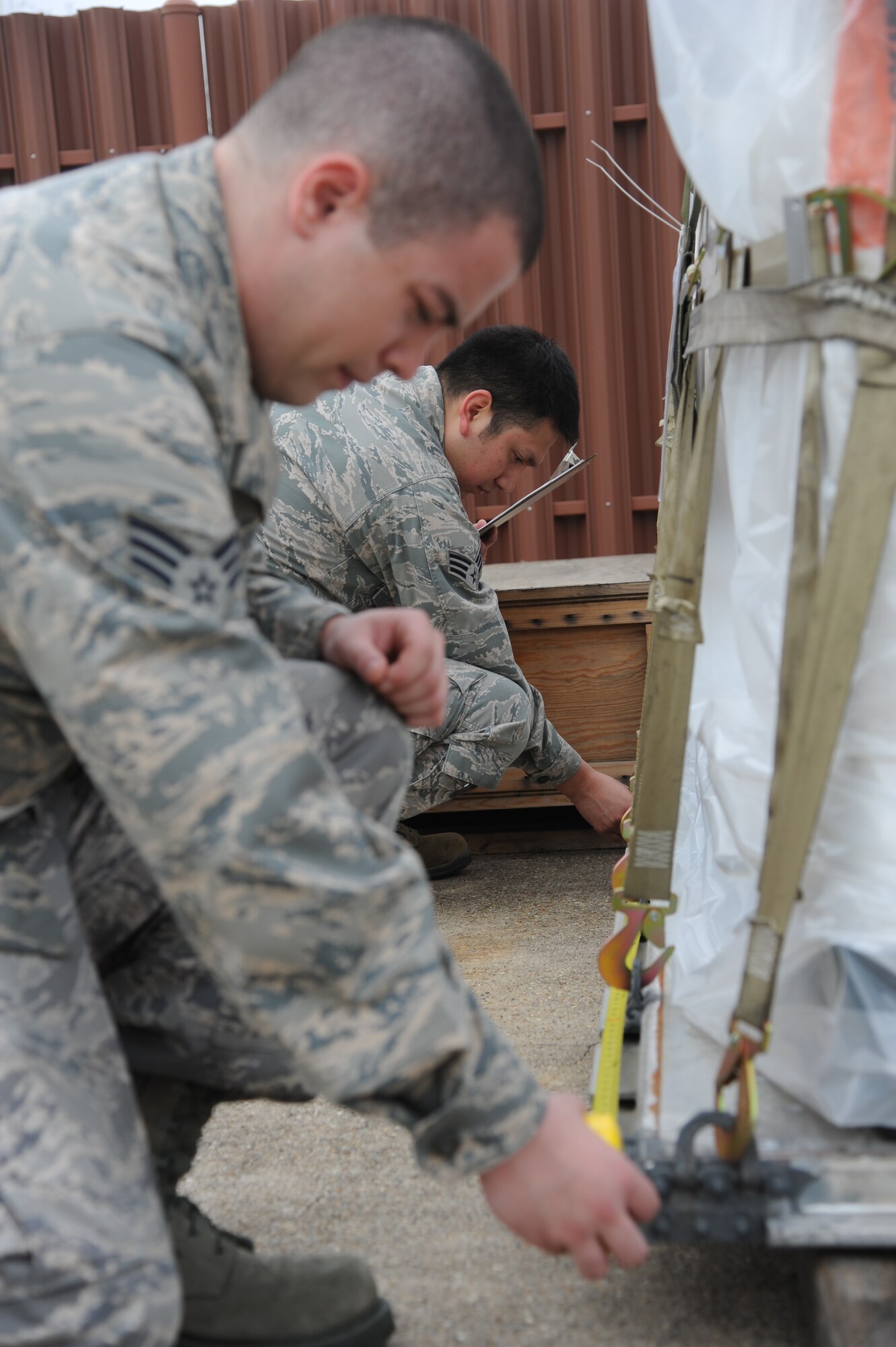 Augmentees Senior Airmen David Burch, 81st Surgical Operations Squadron, (foreground) and Oracio Salinas, 85th Engineering Installation Squadron, measure a cargo pallet while checking incoming cargo during a humanitarian deployment exercise Jan. 29, 2013, at the Taylor Logistics Center, Keesler Air Force Base, Miss.  The exercise scenario consists of an earthquake in Arkansas with a warning order for a deployment to Little Rock, Ark.  (U.S. Air Force photo by Kemberly Groue)