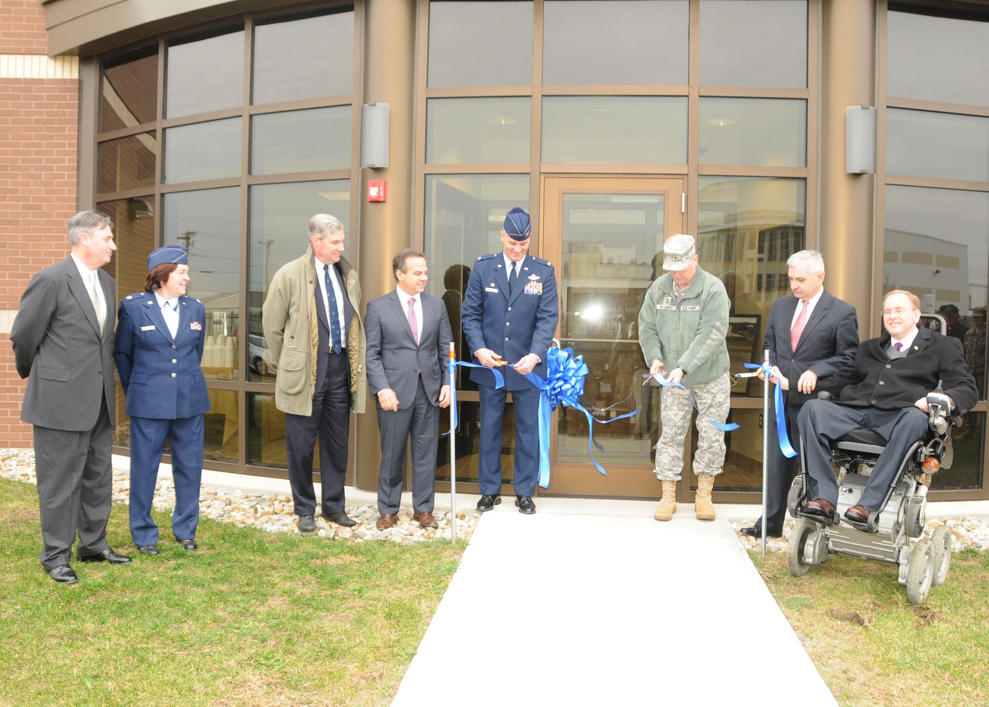 Colonel Arthur Floru, Commander (center left), 143d Airlift Wing, Rhode Island Air National Guard, North Kingstown, Rhode Island, and Major General Kevin McBride (center right), Adjutant General, Commanding General, Rhode Island National Guard cut the ceremonial ribbon in front of the brand new Air Traffic Control Tower at Quonset Air National Guard Base, North Kingstown, RI. Also pictured from Left to Right are Mr. Phillip Cox, Civil Engineer, Lieutenant Colonel Kimberly Keller, 143d Mission Support Group Deputy Commander, Senator Sheldon Whitehouse, Congressman David Cicilline, Senator Jack Reed, and Congressman Jim Langevin. National Guard Photo by Technical Sergeant Jason Long (RELEASED)