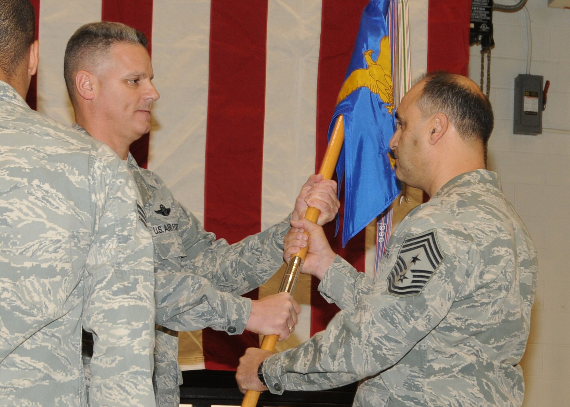 Incomming Command Chief Master Sergeant Jose Baltazar, 143d Airlift Wing (AW), Rhode Island Air National Guard, assumes authority as the Command Chief of the 143d AW from Colonel Arthur Floru, Commander of the 143d AW at a ceremony held at Quonset Air National Guard Base, North Kingstown, Rhode Island. National Guard Photo by Master Sergeant John McDonald (RELEASED)