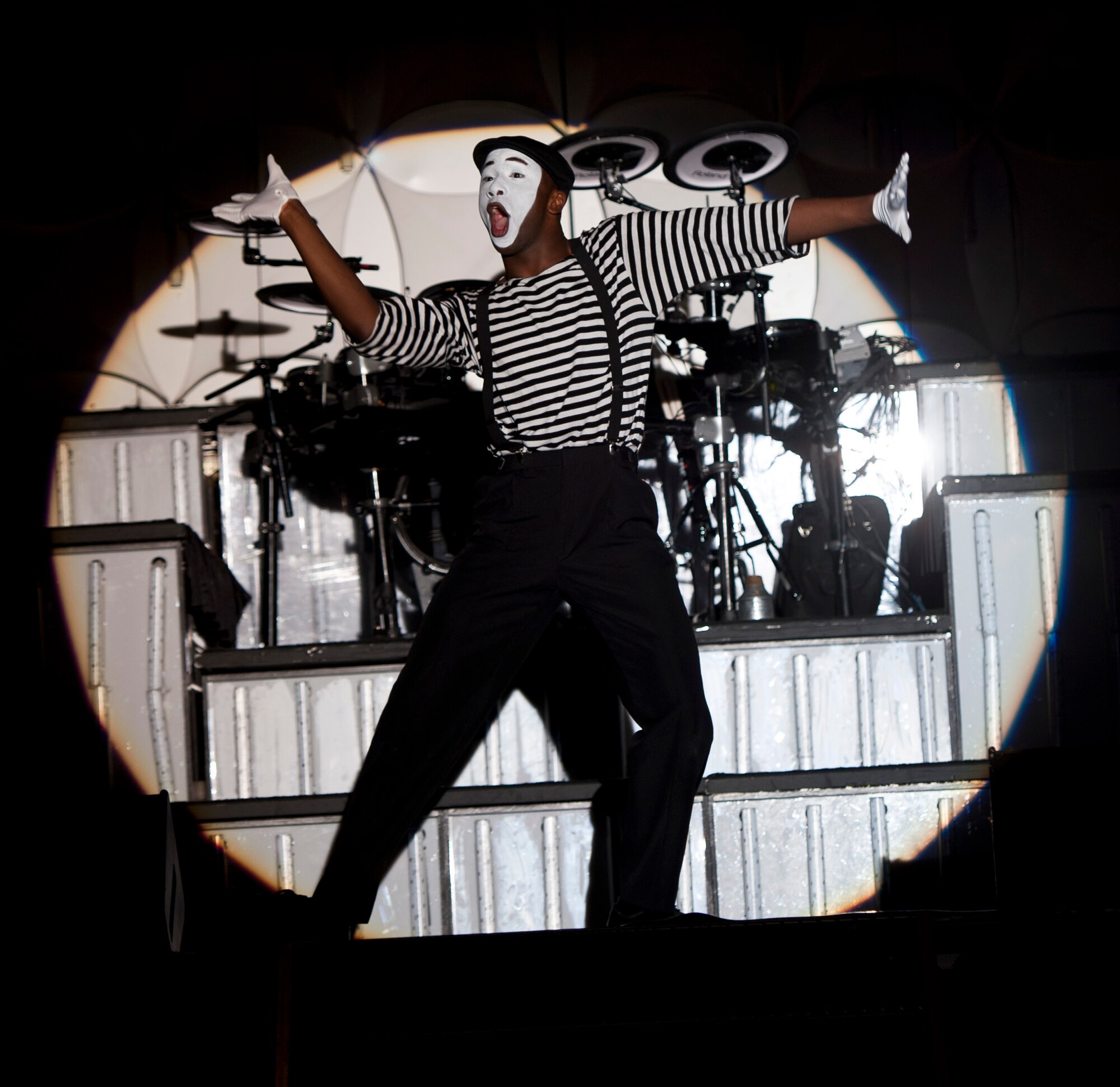 Tops In Blue vocalist, Airman 1st Class Jonathan Leak, performs a mime rendition of “Grenade” by Bruno Mars at the Freedom Hangar on Hurlburty Field, Fla. Jan. 23, 2012. The “Listen” tour invites the audience to listen to the music of life through the sounds that are heard every day. (U.S. Air Force photo by Senior Airman Krystal M. Garrett)  (U.S. Air Force photo by Senior Airman Krystal M. Garrett)