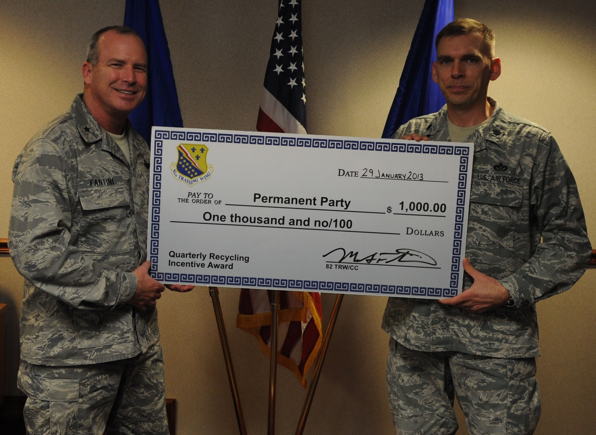 Brig. Gen. Michael Fantini (left), 82nd Training Wing commander, congratulates 82nd Mission Support Group vice-commander Lt. Col. Peter Berube after the group was named as the permanent party award winners for the FY13, 1st Quarter Recycling Awards.  The 82nd MSG collected almost 80,000 pounds of recyclables this quarter. (U.S. Air Force photo/Airman 1st Class Jelani Gibson)