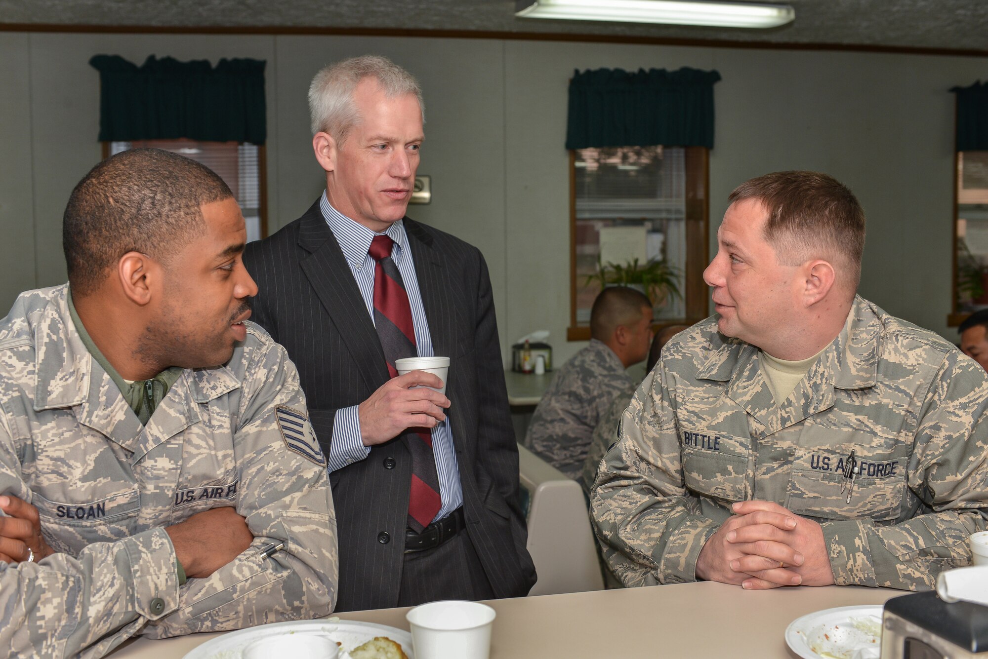 National Guard Master Sgt. Charles Bittle (right) and Tech. Sgt. Jonathan Sloan speak with retired Col. Todd Harmer, Military Legislative Assistant to Senator Saxby Chambliss, January 25, 2013 at Savannah Air National Guard base in Garden City, Ga. Harmer met with members of the 165th Airlift Wing to provide answer for legislative questions of concern to Georgia Air National Guard Airmen. (National Guard photo by Tech. Sgt. Charles Delano/released)