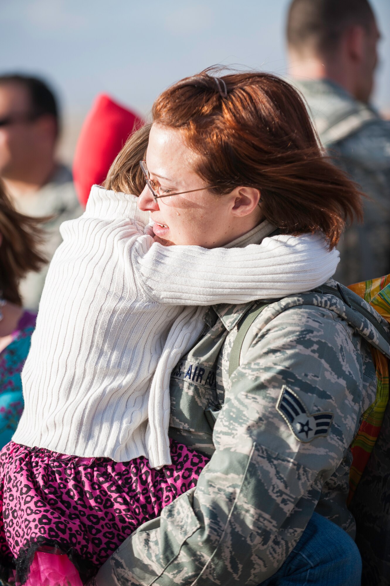 A Senior Airman returning from deployment greets her daughter after landing on the Holloman AFB, N.M., flightline Jan. 28.  F-22 Raptors and around 200 personnel returned Monday from a 9-month deployment to Southwest Asia ensuring regional security and joint tactical air operations.  (U.S. Air Force Photo by 1st Lt. Stephanie Schonberger/Released)