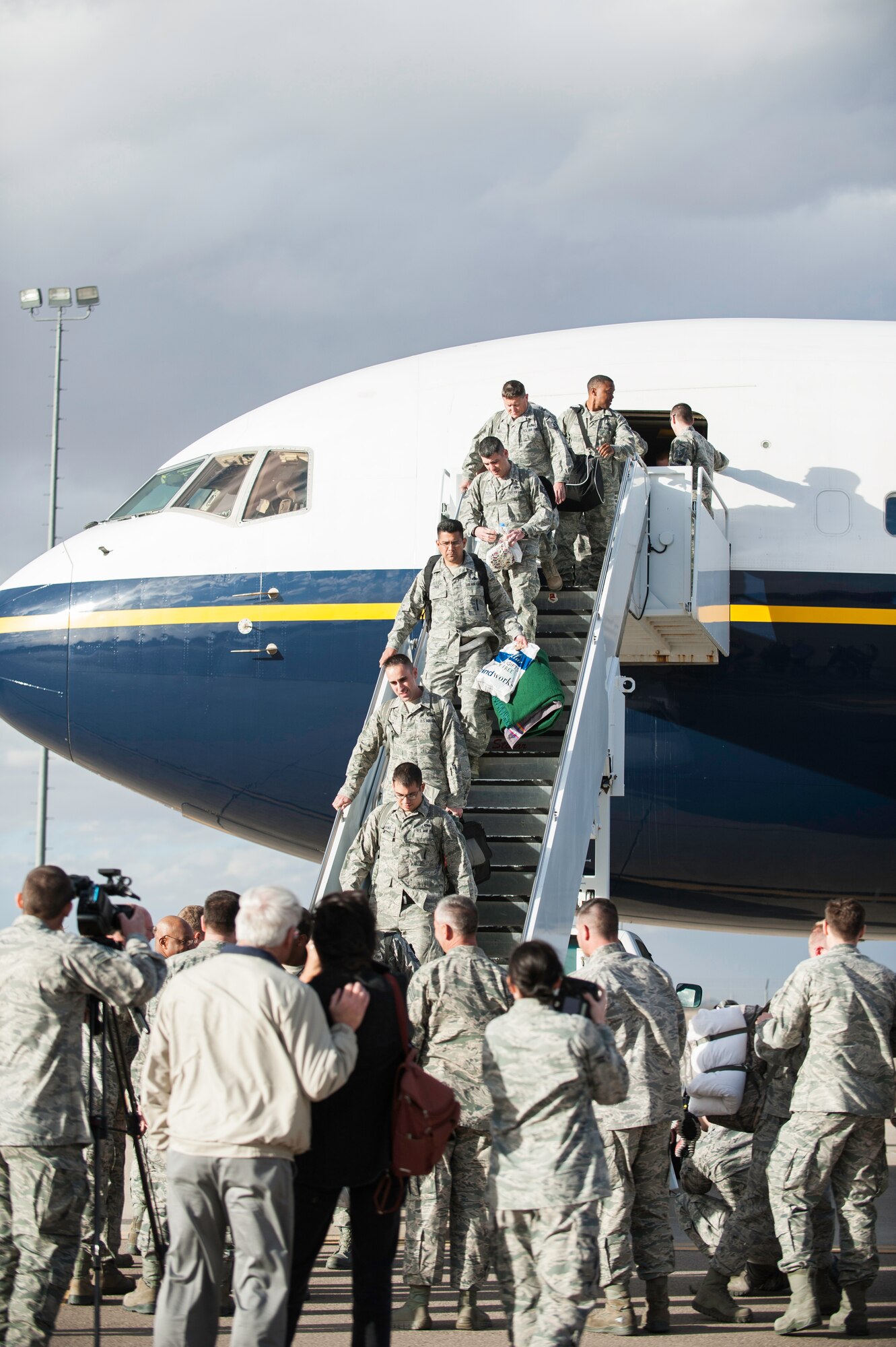 Returning Airmen de-plane and are greeted by 49th Wing leadership after arriving on the Holloman AFB, N.M., flightline Jan. 28.  F-22 Raptors and around 200 personnel returned Monday from a 9-month deployment to Southwest Asia ensuring regional security and joint tactical air operations.  (U.S. Air Force photo by 1st Lt. Stephanie Schonberger/Released)