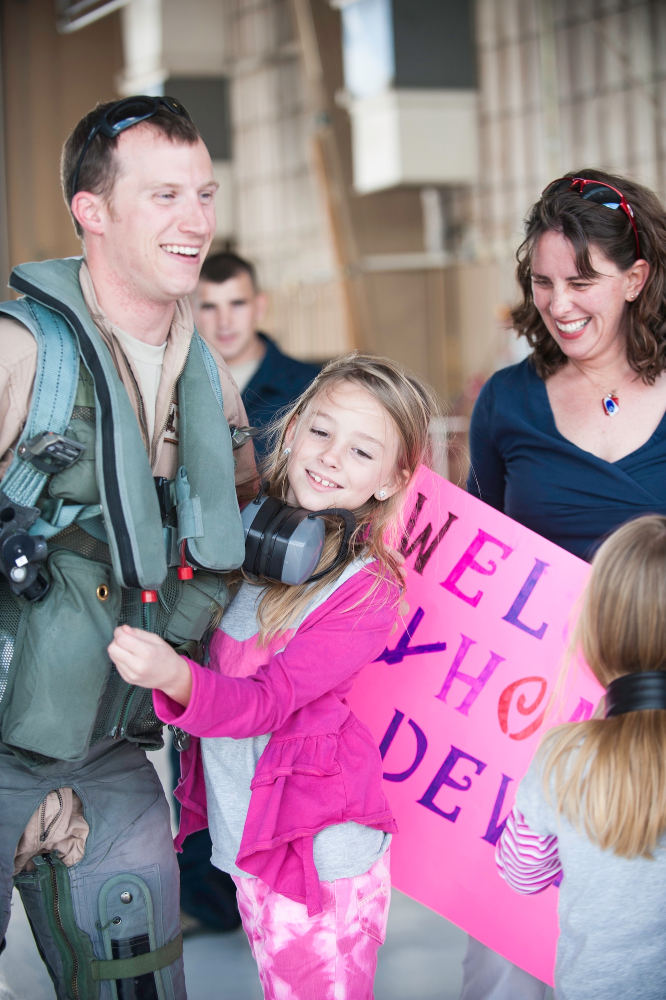 Captain Harrison Garlick, 7th Fighter Squadron F-22 Raptor pilot, greets awaiting friends and family after landing on the Holloman AFB, N.M., flightline Jan. 28.  The aircraft and around 200 personnel returned Monday from a 9-month deployment to Southwest Asia ensuring regional security and joint tactical air operations.  (U.S. Air Force photo by 1st Lt. Stephanie Schonberger/Released)