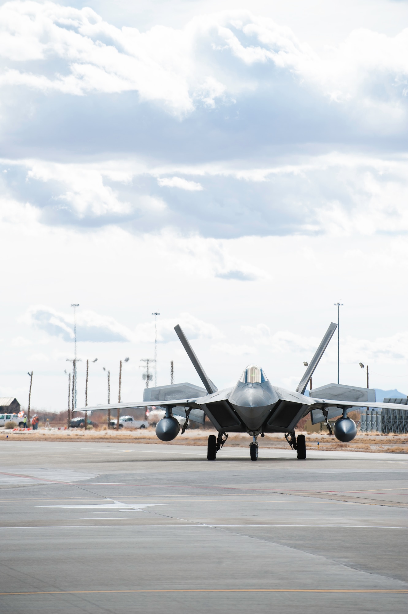 An F-22 Raptor returning from deployment taxis toward a hangar on the Holloman AFB, N.M., flightline Jan. 28.  The aircraft and around 200 personnel returned Monday from a 9-month deployment to southwest Asia ensuring regional security and joint tactical air operations.  (U.S. Air Force photo by 1st Lt. Stephanie Schonberger/Released)
