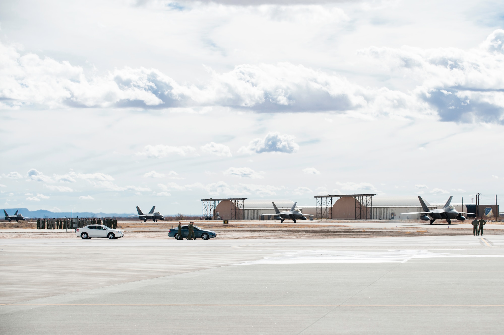 Four F-22 Raptors returning from deployment taxi toward a hangar on the Holloman AFB, N.M., flightline Jan. 28.  The aircraft and around 200 personnel returned Monday from a 9-month deployment to Southwest Asia ensuring regional security and joint tactical air operations.  (U.S. Air Force photo by 1st Lt. Stephanie Schonberger/Released)