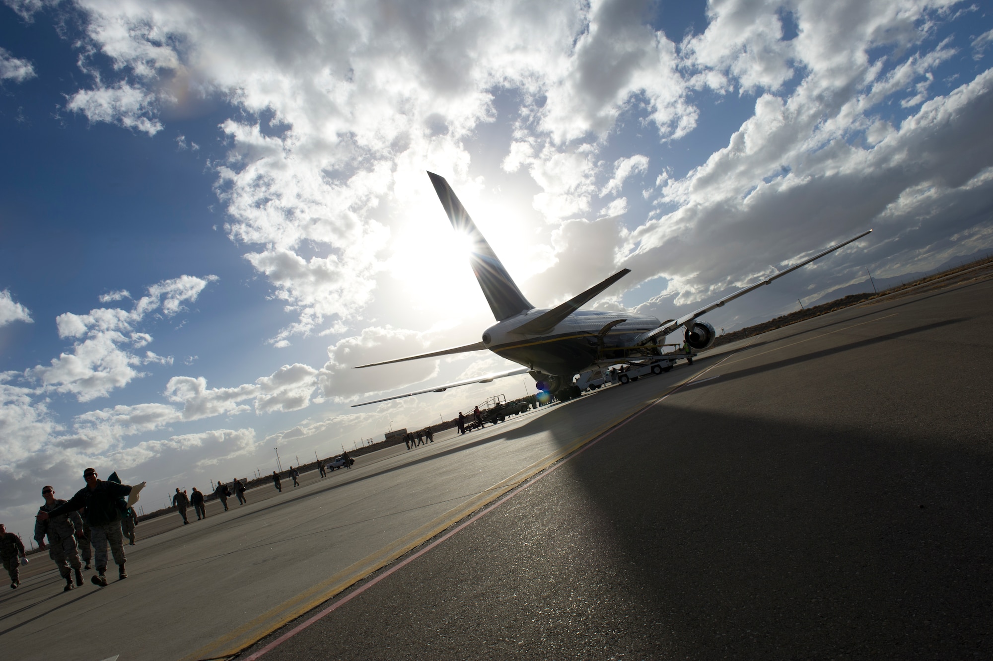 Airmen from the 7th Fighter Squadron and the 49th Maintenance deplane after landing at Holloman Air Force Base, N.M., Jan. 28. F-22 Raptors and around 200 personnel returned Monday from a 9-month deployment to Southwest Asia ensuring regional security and joint tactical air operations. (U.S. Air Force photo by Airman 1st Class Michael Shoemaker/Released)