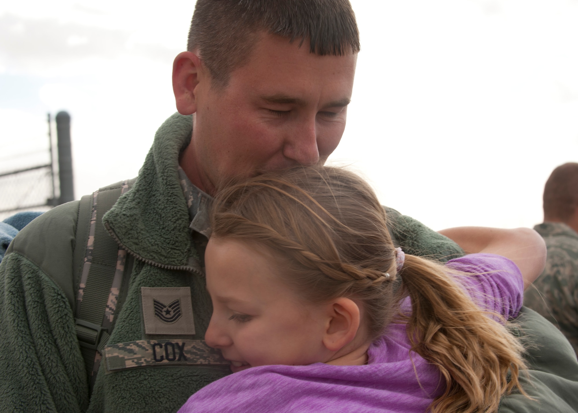 Technical Sgt Jonathan Cox, 49th Maintenance Group, deplanes and finally reunites with his family on the Holloman AFB, N.M., flightline Jan. 28.  The aircraft and around 200 personnel returned Monday from a 9-month deployment to Southwest Asia ensuring regional security and joint tactical air operations. (U.S. Air Force photo by Airman 1st Class Leah Murray/Released)