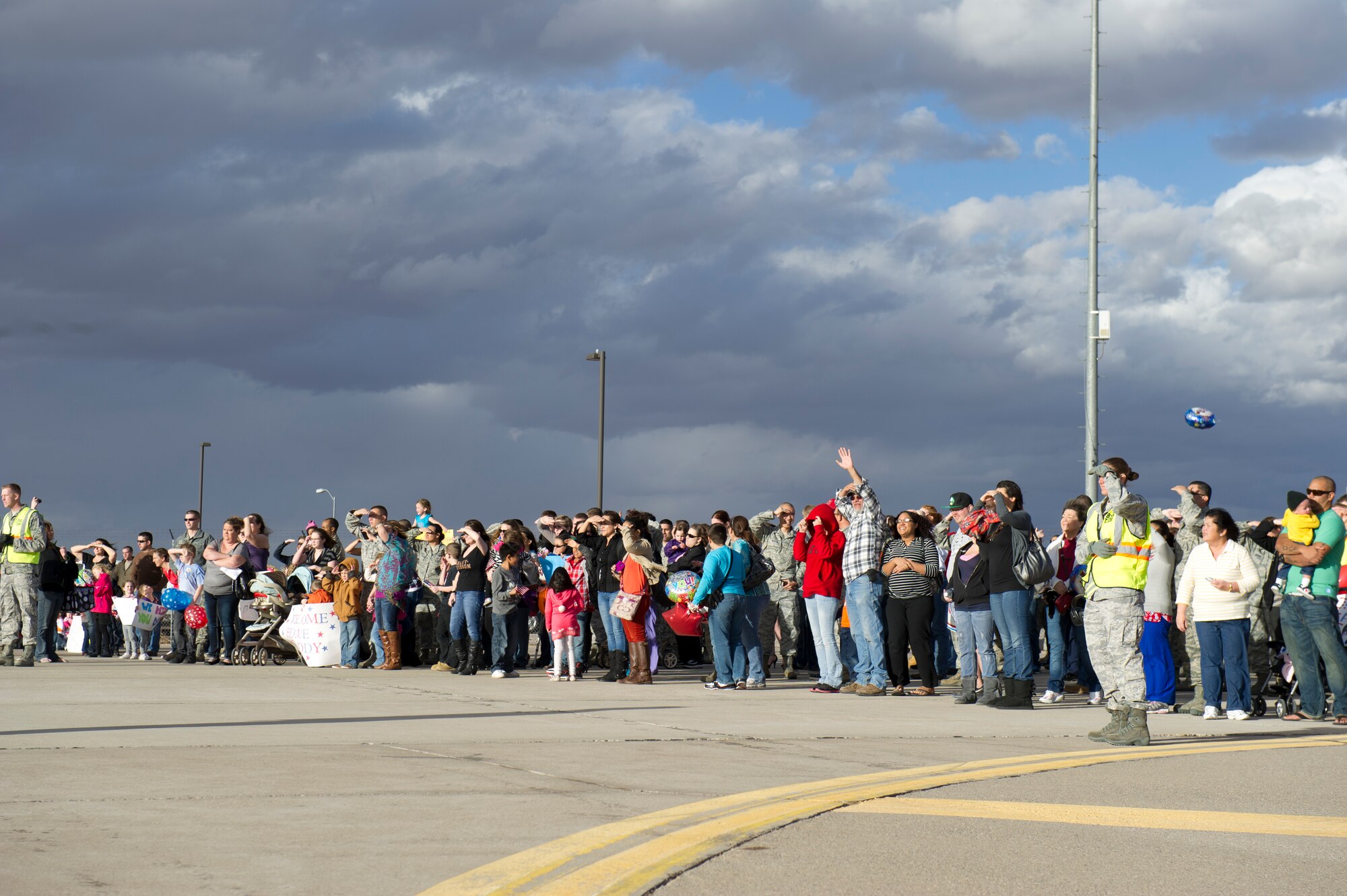 Friends and family await the return of around 200 Airmen from the 7th Fighter Squadron and the 49th Maintenance Group on the Holloman Air Force Base, N.M. flightline, Jan. 28. F-22 Raptors and around 200 personnel returned Monday from a 9-month deployment to Southwest Asia ensuring regional security and joint tactical air operations. (U.S. Air Force photo by Airman 1st Class Michael Shoemaker/Released)