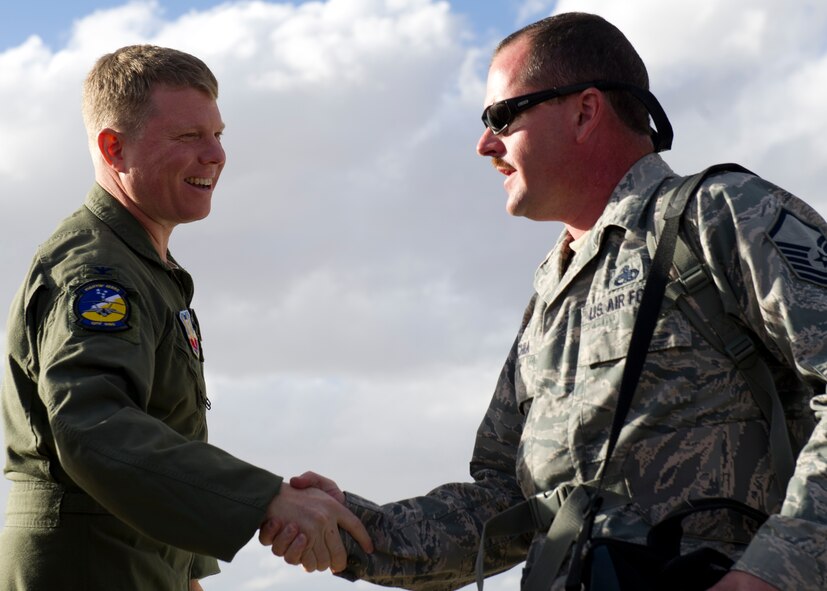 Colonel Andrew Croft, 49th Wing commander, welcomes back returning Airmen on the Holloman Air Force Base, N.M. flightline, Jan. 28. F-22 Raptors and around 200 personnel returned Monday from a 9-month deployment to Southwest Asia ensuring regional security and joint tactical air operations. (U.S. Air Force photo by Airman 1st Class Michael Shoemaker/Released)
