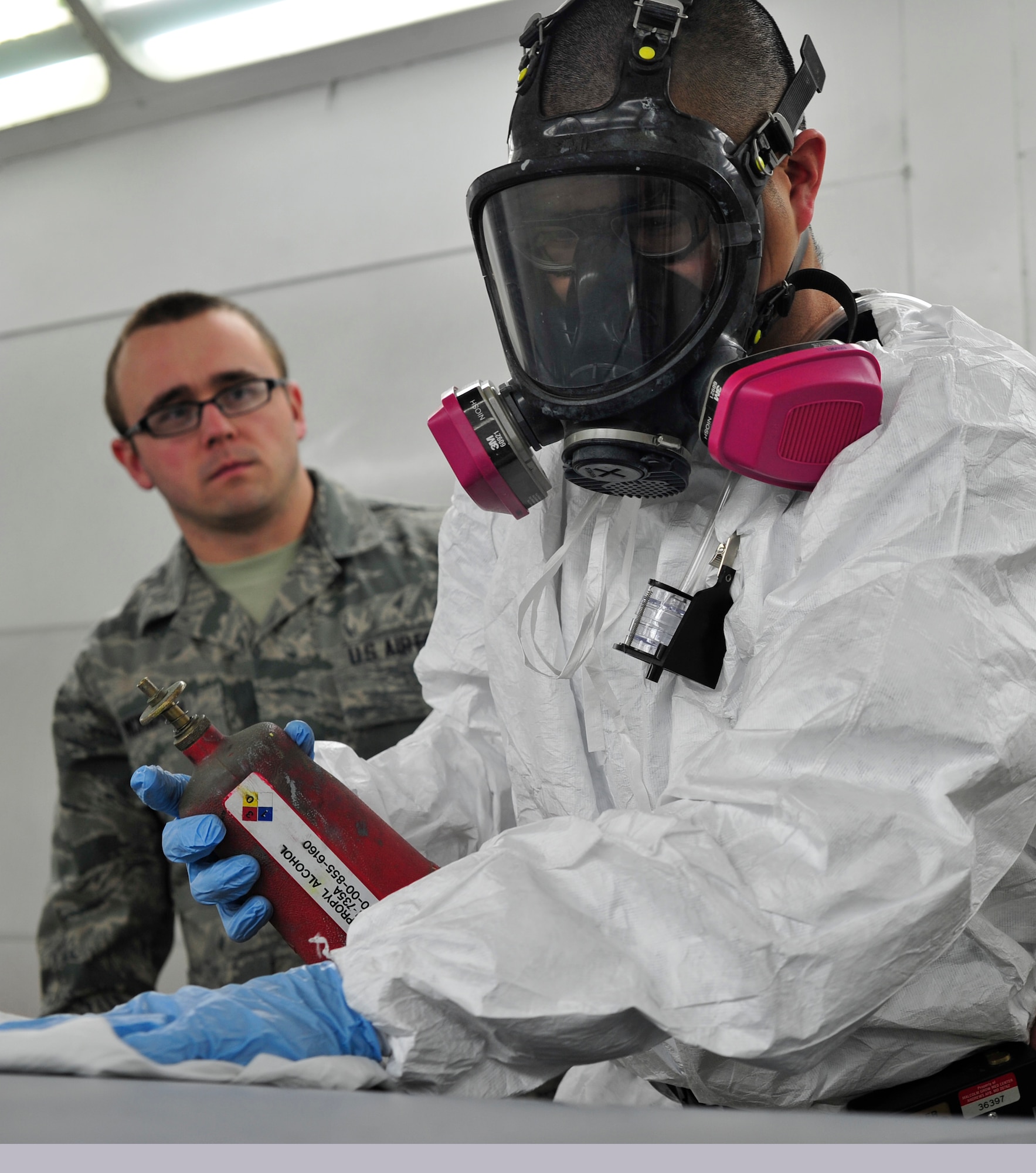 Tech. Sgt. John Mills-Hearne, a painter with the 459th Reserve Air Refueling Wing, is observed by Airman Thomas McMahon, 779th Aerospace Medicine Squadron bioenvironmental engineering technician, as he demonstrates the proper painting techniques on an aircraft Jan. 23, 2013 at Joint Base Andrews, Md. Bioenvironmental engineers are required to sample on location to help monitor the amount of chemicals workers are exposed to. (U.S Air Force photo/ Airman 1st Class Erin O’Shea)